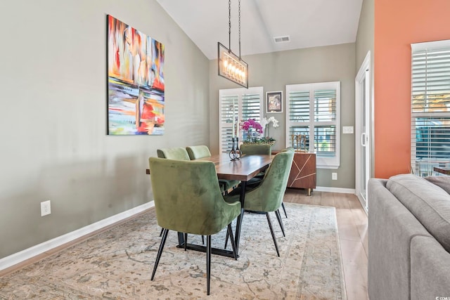 dining room featuring a chandelier and baseboards