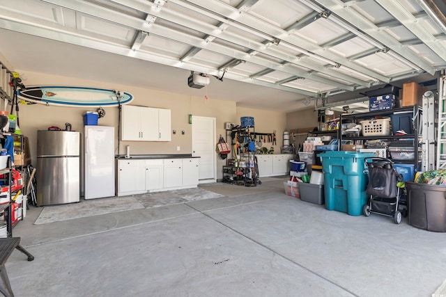 122 New Paradise Way, Myrtle Beach, SC 29588 - garage with freestanding refrigerator and a garage door opener