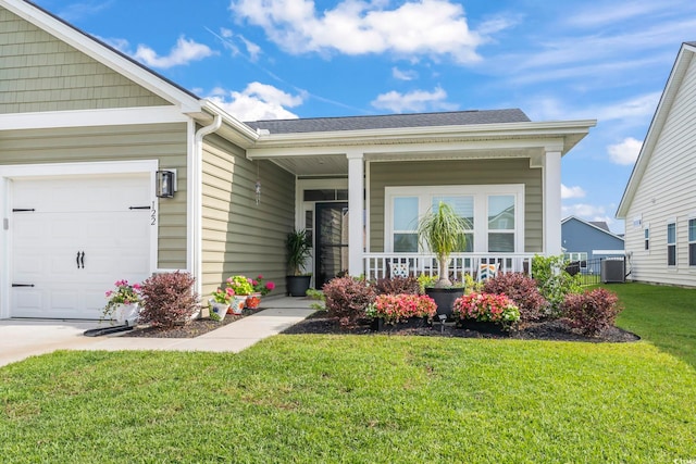 view of exterior entry with a yard, a porch, an attached garage, and central air condition unit