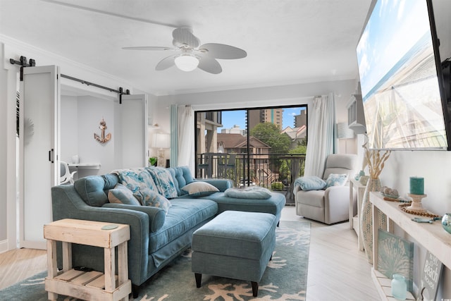 307 74th Ave N Unit 3C, Myrtle Beach, SC 29572 - living area with a barn door, ornamental molding, light wood-type flooring, and a ceiling fan