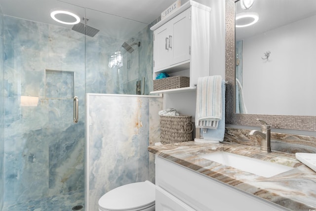 307 74th Ave N Unit 3C, Myrtle Beach, SC 29572 - bathroom with vanity, a stall shower, and toilet