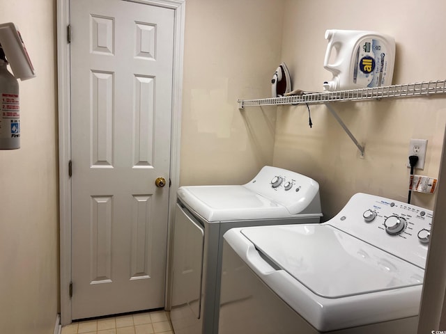 laundry area featuring independent washer and dryer and light tile patterned flooring