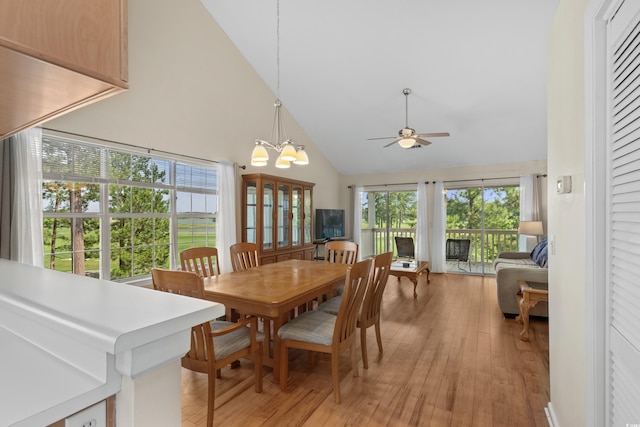 4940 Windsor Green Way Unit 301, Myrtle Beach, SC 29579 - dining room featuring high vaulted ceiling, light wood-style flooring, ceiling fan, and a chandelier