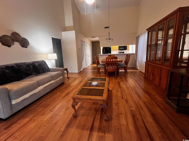 living area with a high ceiling and dark wood finished floors