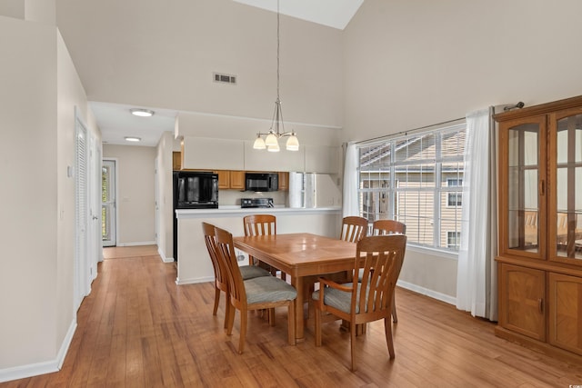 4940 Windsor Green Way Unit 301, Myrtle Beach, SC 29579 - dining room featuring high vaulted ceiling, a chandelier, baseboards, and light wood finished floors