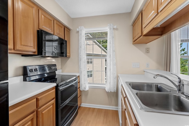 4940 Windsor Green Way Unit 301, Myrtle Beach, SC 29579 - kitchen featuring double oven range, black microwave, a sink, and plenty of natural light