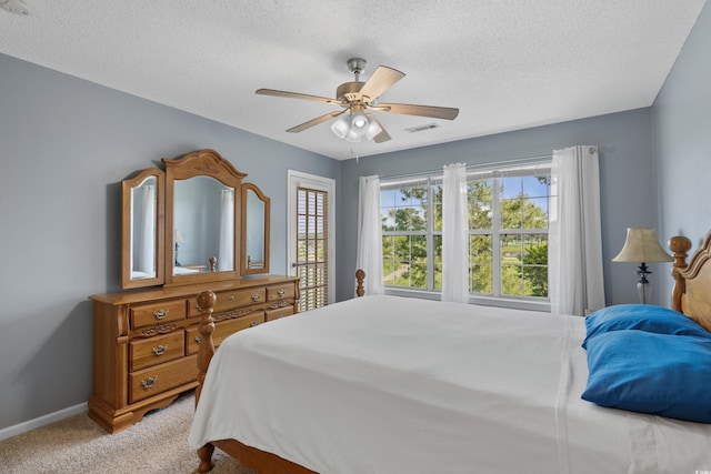 4940 Windsor Green Way Unit 301, Myrtle Beach, SC 29579 - bedroom featuring multiple windows, light carpet, a textured ceiling, baseboards, and ceiling fan