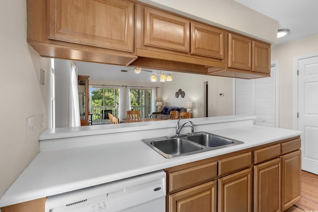 4940 Windsor Green Way Unit 301, Myrtle Beach, SC 29579 - kitchen with a sink, white dishwasher, light countertops, and light wood-style flooring