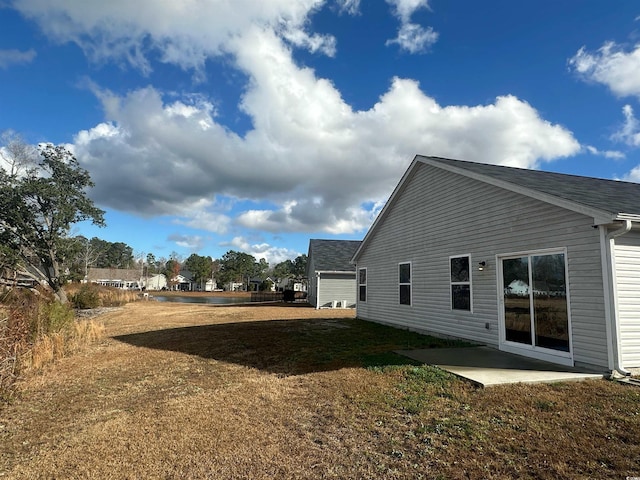 198 Foxford Dr, Conway, SC 29526 - view of side of home featuring a patio area, a lawn, and roof with shingles