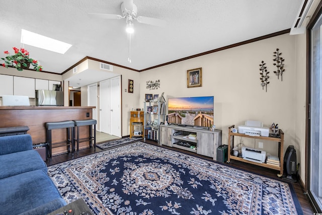 4350 Intercoastal Dr Unit 2402, Little River, SC 29566 - living room featuring a skylight, wood finished floors, a ceiling fan, a textured ceiling, and ornamental molding