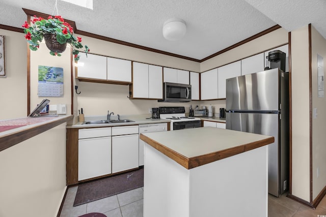 4350 Intercoastal Dr Unit 2402, Little River, SC 29566 - kitchen featuring stainless steel appliances, white cabinets, light tile patterned floors, a textured ceiling, and light countertops