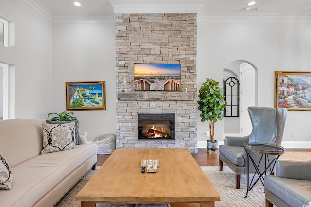 7202 Seville Dr, Myrtle Beach, SC 29572 - living room with a fireplace, ornamental molding, wood finished floors, arched walkways, and baseboards