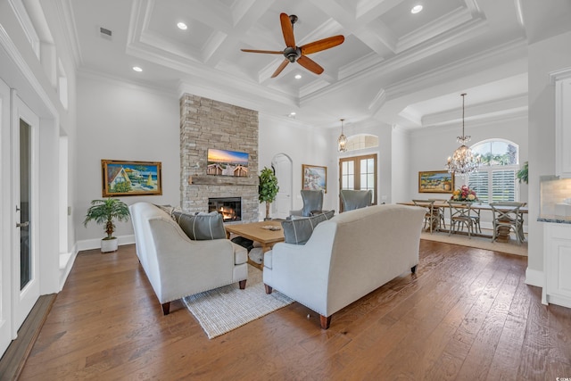 7202 Seville Dr, Myrtle Beach, SC 29572 - living area featuring healthy amount of natural light, a fireplace, dark wood-type flooring, crown molding, and a ceiling fan
