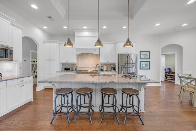7202 Seville Dr, Myrtle Beach, SC 29572 - kitchen featuring arched walkways, stainless steel appliances, a sink, tasteful backsplash, and recessed lighting