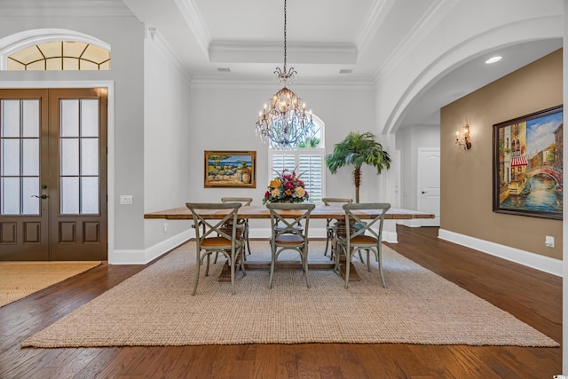7202 Seville Dr, Myrtle Beach, SC 29572 - dining space featuring french doors, dark wood-type flooring, baseboards, arched walkways, and crown molding