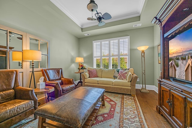 7202 Seville Dr, Myrtle Beach, SC 29572 - living area featuring a tray ceiling, wood-type flooring, baseboards, crown molding, and ceiling fan