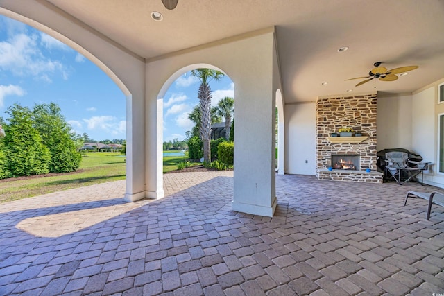 7202 Seville Dr, Myrtle Beach, SC 29572 - view of patio featuring an outdoor stone fireplace and a ceiling fan