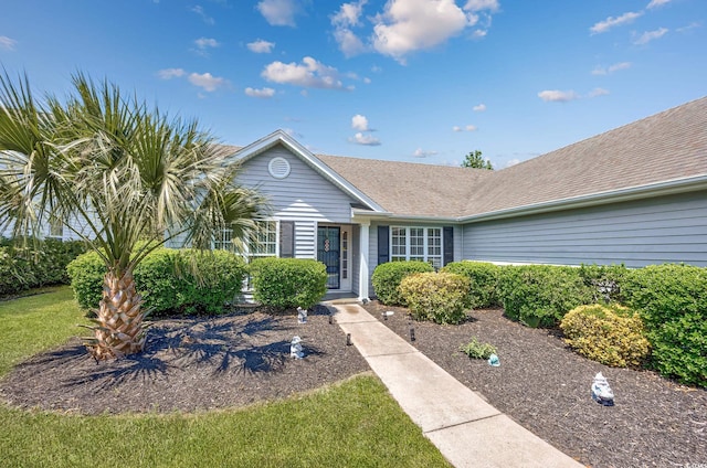 ranch-style house with a shingled roof