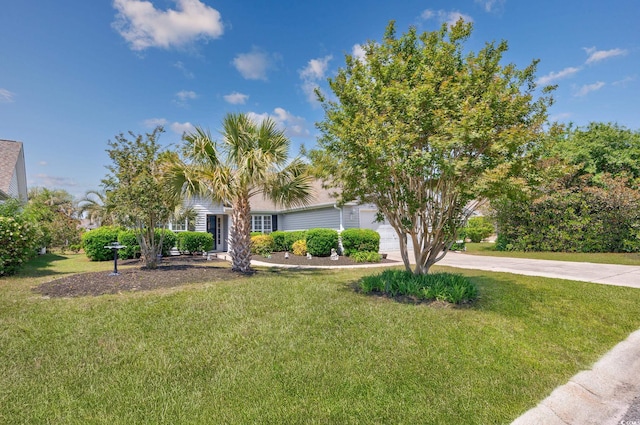 view of front of house with driveway, a front yard, and a garage