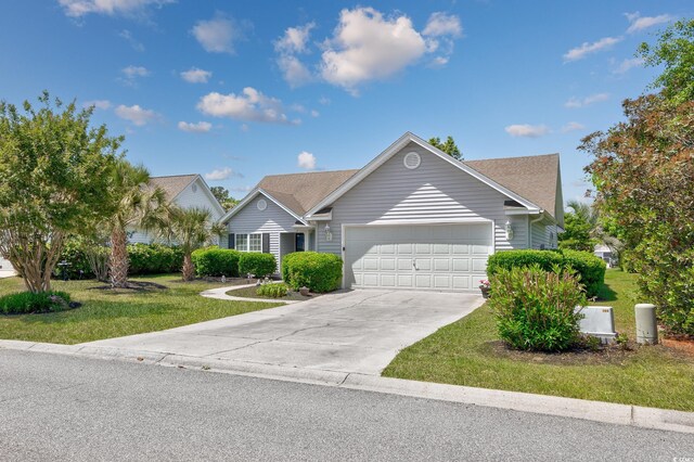 ranch-style house featuring an attached garage, a front lawn, and driveway