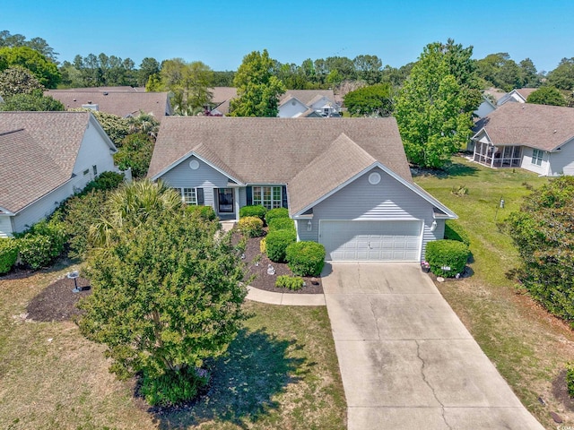 view of front of house with a garage, concrete driveway, and a front yard