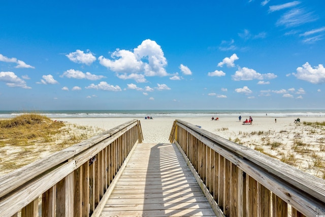 view of home's community featuring view of water and beach