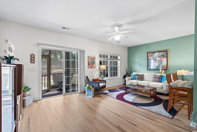 1058 Sea Mountain Hwy Unit 9-101, North Myrtle Beach, SC 29582 - living area featuring a textured ceiling, ceiling fan, and wood finished floors