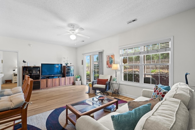 1058 Sea Mountain Hwy Unit 9-101, North Myrtle Beach, SC 29582 - living room featuring ceiling fan, wood finished floors, and a textured ceiling