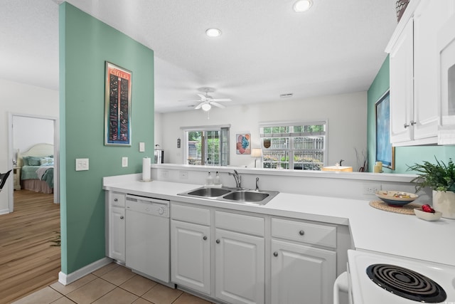 1058 Sea Mountain Hwy Unit 9-101, North Myrtle Beach, SC 29582 - kitchen featuring white dishwasher, stove, light countertops, white cabinetry, and a ceiling fan