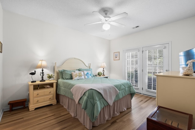 1058 Sea Mountain Hwy Unit 9-101, North Myrtle Beach, SC 29582 - bedroom featuring access to exterior, wood finished floors, a textured ceiling, and ceiling fan