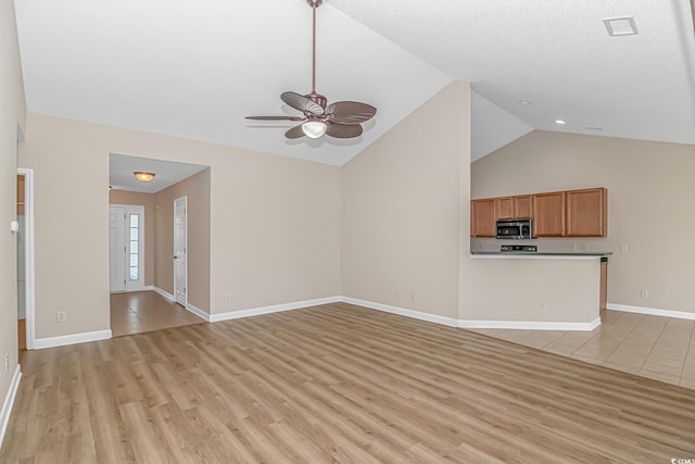 5 Coffee Mill Creek Ln, Carolina Shores, NC 28467 - unfurnished living room with lofted ceiling, ceiling fan, light wood-style flooring, and baseboards