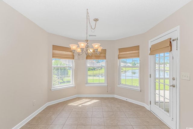 5 Coffee Mill Creek Ln, Carolina Shores, NC 28467 - unfurnished dining area featuring a water view, a chandelier, light tile patterned floors, and baseboards