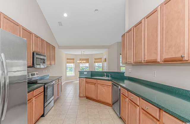 5 Coffee Mill Creek Ln, Carolina Shores, NC 28467 - kitchen with appliances with stainless steel finishes, a chandelier, dark countertops, light tile patterned floors, and vaulted ceiling