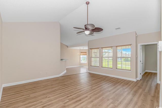5 Coffee Mill Creek Ln, Carolina Shores, NC 28467 - unfurnished living room with a ceiling fan, baseboards, light wood finished floors, a chandelier, and high vaulted ceiling