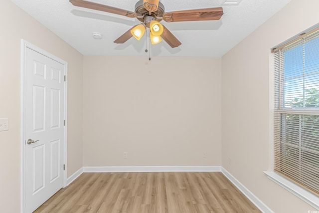 5 Coffee Mill Creek Ln, Carolina Shores, NC 28467 - empty room with light wood-type flooring, a smoke detector, baseboards, a ceiling fan, and a textured ceiling