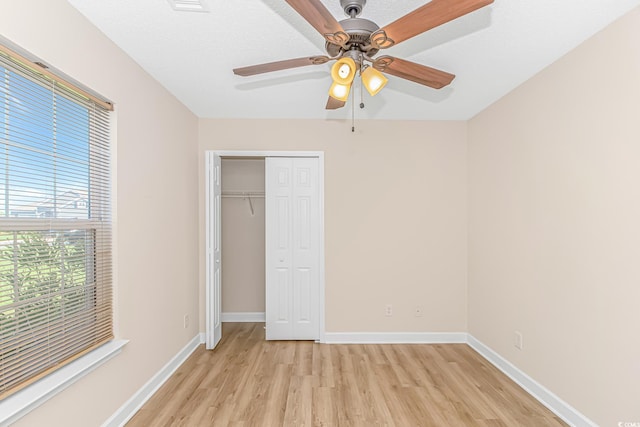 5 Coffee Mill Creek Ln, Carolina Shores, NC 28467 - unfurnished bedroom with light wood finished floors, baseboards, a closet, and a ceiling fan
