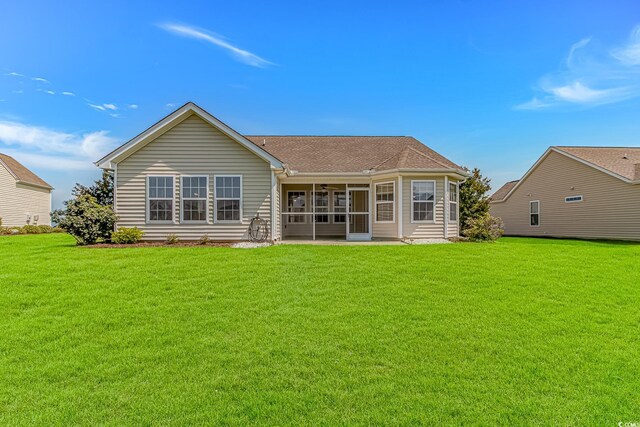5 Coffee Mill Creek Ln, Carolina Shores, NC 28467 - rear view of property featuring a sunroom, a lawn, ceiling fan, and roof with shingles