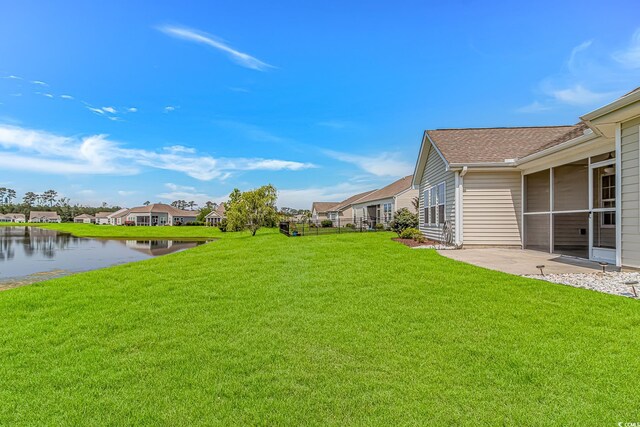 5 Coffee Mill Creek Ln, Carolina Shores, NC 28467 - view of grassy yard featuring a water view, a patio, and a residential view