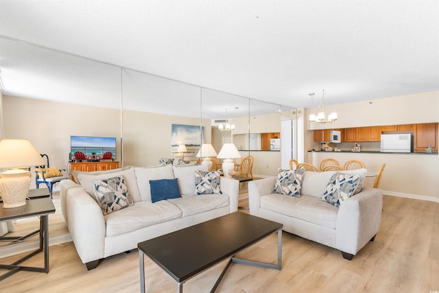 9820 Queensway Blvd Unit 804, Myrtle Beach, SC 29572 - living room with a chandelier, light wood-type flooring, and baseboards