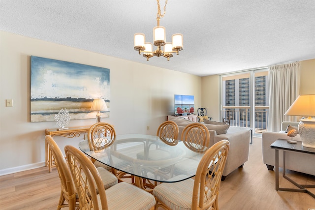 9820 Queensway Blvd Unit 804, Myrtle Beach, SC 29572 - dining area with wood finished floors, a chandelier, a textured ceiling, and baseboards