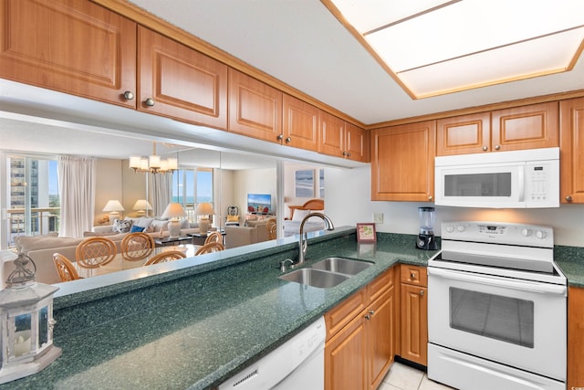 9820 Queensway Blvd Unit 804, Myrtle Beach, SC 29572 - kitchen with white appliances, a sink, open floor plan, a chandelier, and dark stone counters
