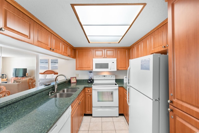 9820 Queensway Blvd Unit 804, Myrtle Beach, SC 29572 - kitchen with white appliances, a sink, light tile patterned flooring, brown cabinetry, and dark stone countertops