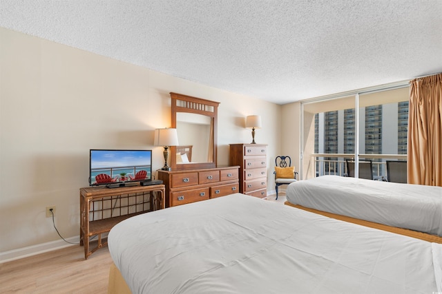 9820 Queensway Blvd Unit 804, Myrtle Beach, SC 29572 - bedroom featuring wood finished floors, a textured ceiling, and baseboards