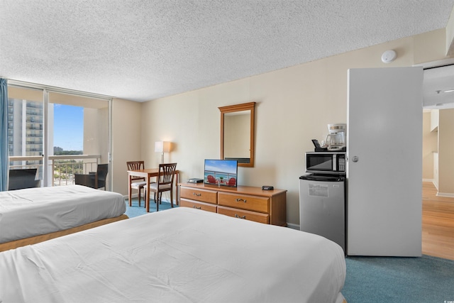 9820 Queensway Blvd Unit 804, Myrtle Beach, SC 29572 - bedroom with fridge, a textured ceiling, and access to outside