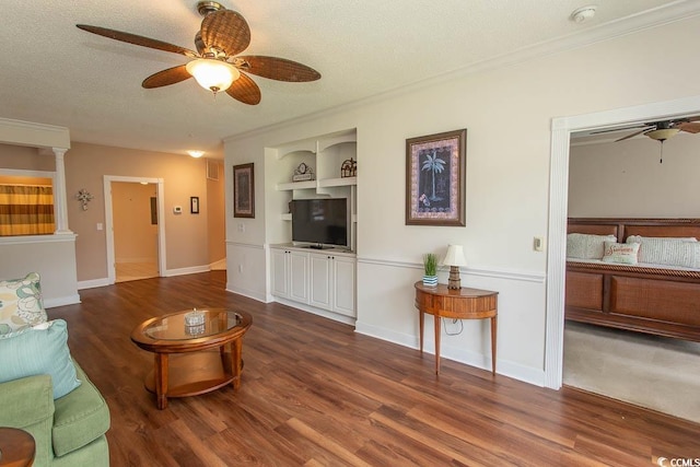 2241 Waterview Dr Unit 315, North Myrtle Beach, SC 29582 - living room featuring ceiling fan, wood finished floors, built in shelves, a textured ceiling, and ornamental molding