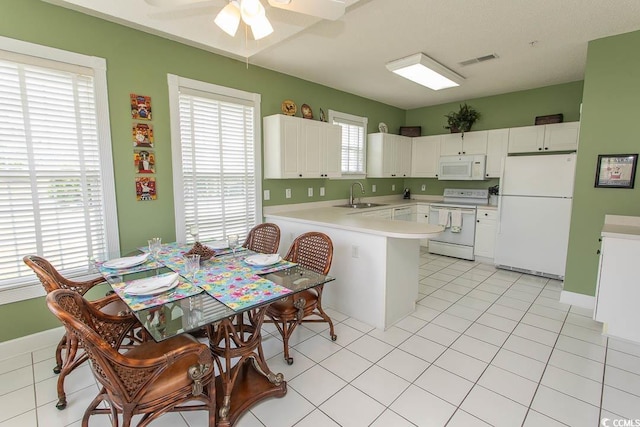 2241 Waterview Dr Unit 315, North Myrtle Beach, SC 29582 - kitchen with white appliances, a sink, a peninsula, light countertops, and a ceiling fan