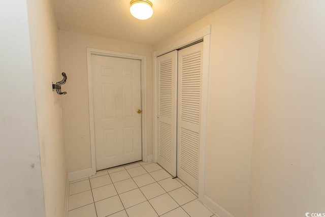 2241 Waterview Dr Unit 315, North Myrtle Beach, SC 29582 - hallway with light tile patterned floors, a textured ceiling, and baseboards