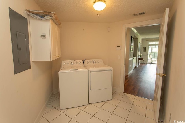 2241 Waterview Dr Unit 315, North Myrtle Beach, SC 29582 - clothes washing area with cabinet space, separate washer and dryer, electric panel, baseboards, and light tile patterned floors