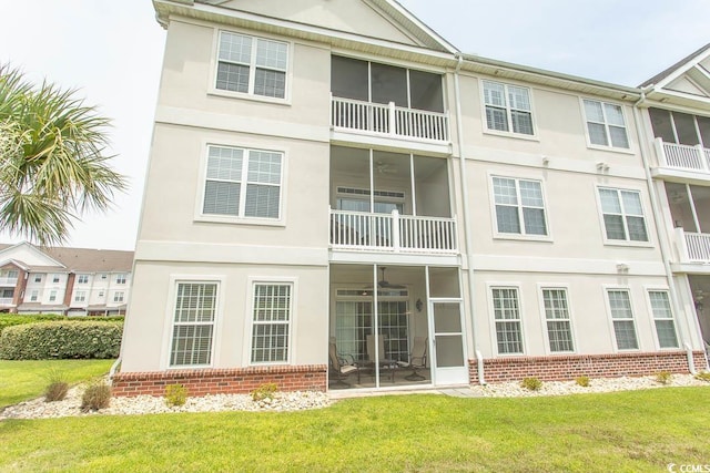 2241 Waterview Dr Unit 315, North Myrtle Beach, SC 29582 - rear view of house with brick siding, stucco siding, and a lawn