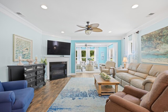 1290 Prescott Cir, Myrtle Beach, SC 29577 - living room with a ceiling fan, ornamental molding, recessed lighting, dark wood-style flooring, and a fireplace with flush hearth